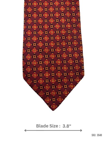 Burgundy silk tie with red and orange geometric medallion pattern – front blade view